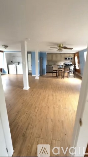 A room with wooden floors and a ceiling fan.