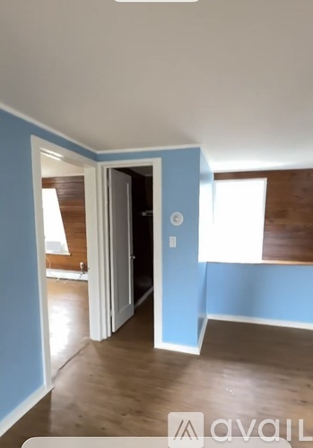 A room with blue walls and wooden floors.