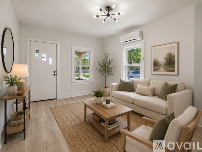 A living room with a couch, chair, and coffee table.