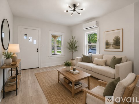 A living room with a couch, chair, and coffee table.