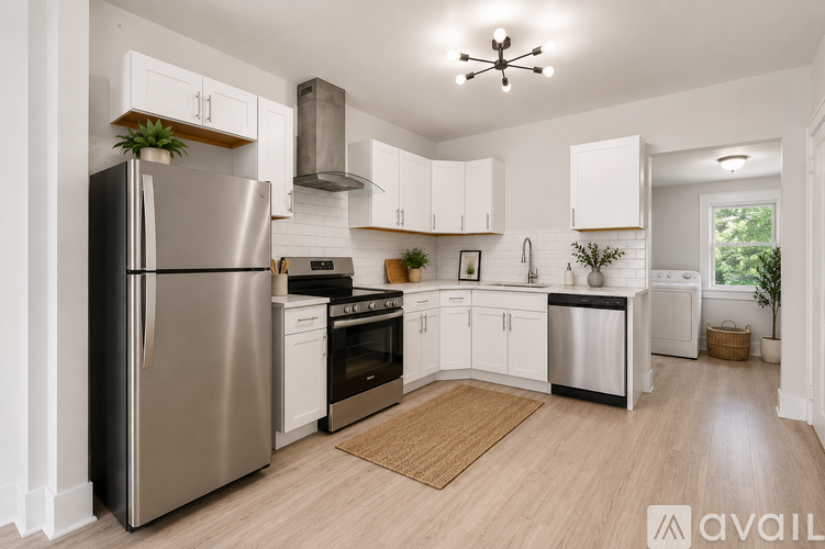A modern kitchen with stainless steel appliances and white cabinetry.