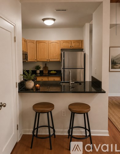 A kitchen with wooden cabinets and black countertops.