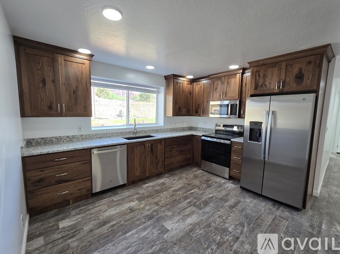 A kitchen with wooden cabinets and a refrigerator.