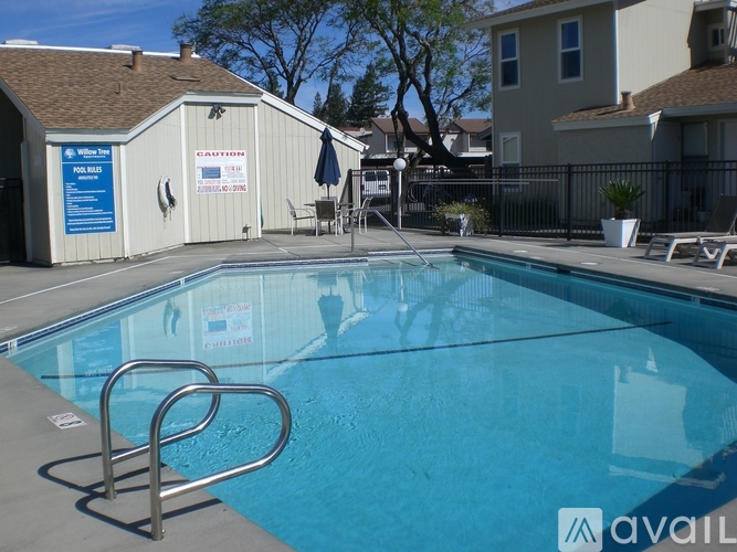 A pool with a diving board and a sign that says "CAUTION".