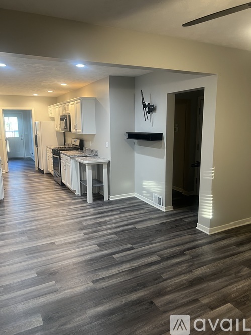 A kitchen area with a counter and cabinets.