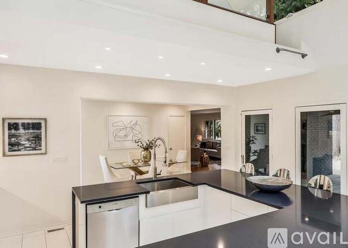 A modern kitchen with a dining table and chairs.