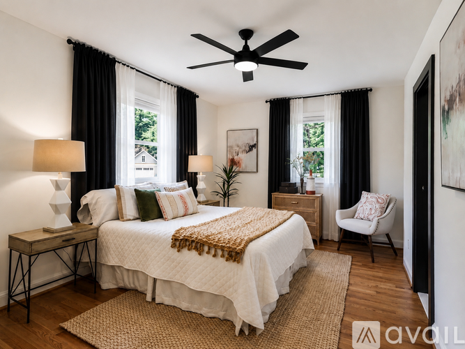 A bedroom with a large bed and a ceiling fan.