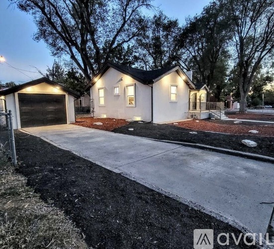 A house with a driveway and garage is available for sale.
