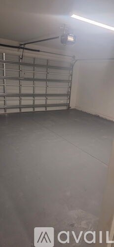 A garage door opener is hanging from the ceiling.
