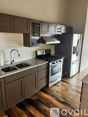 A kitchen with wooden floors and modern appliances.