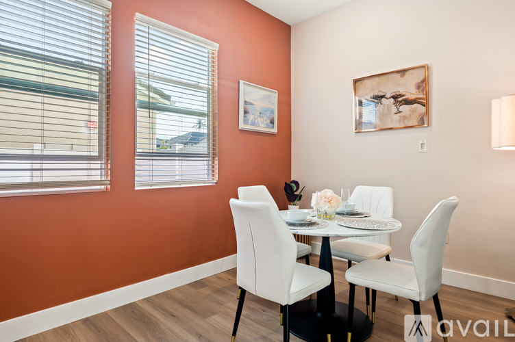 A dining room with a table set for two.