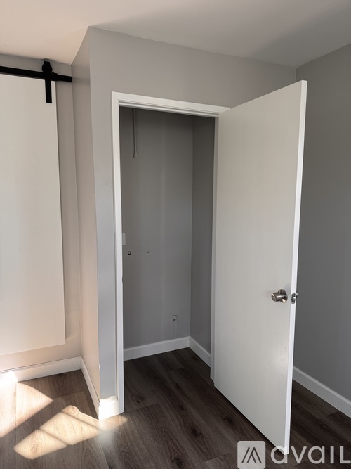 A room with a white door and a white wall.
