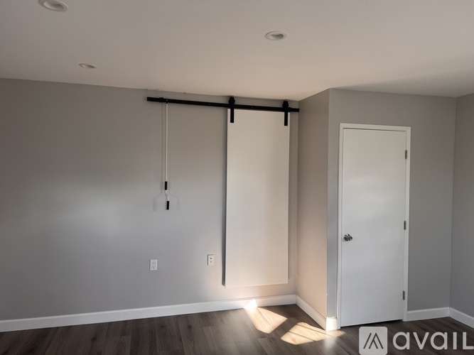 A room with a sliding door and a white door.
