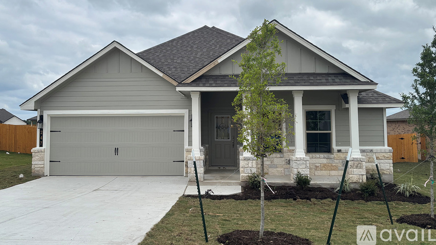 A house with a grey roof and a garage door.