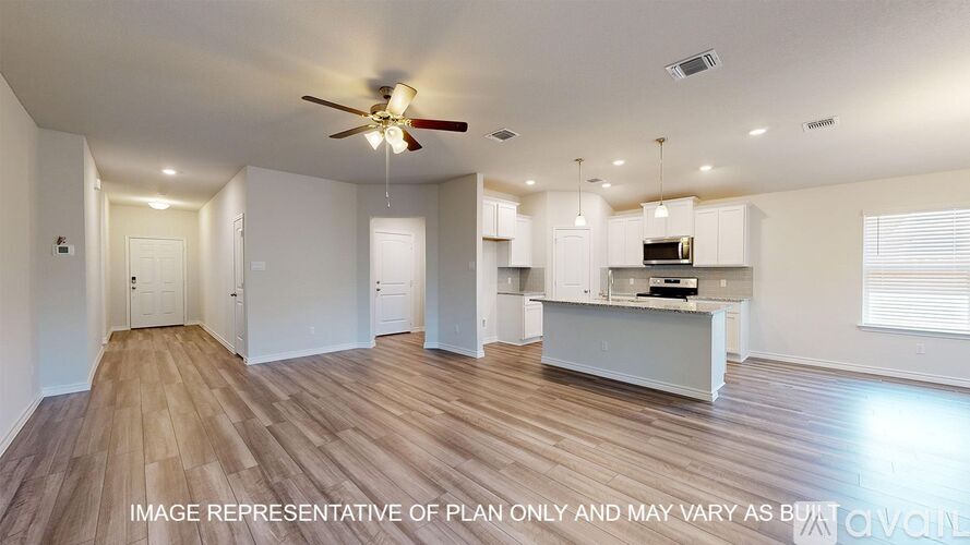 A spacious room with a ceiling fan and wooden flooring.