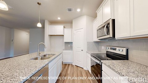 A kitchen with white cabinets and a granite countertop.