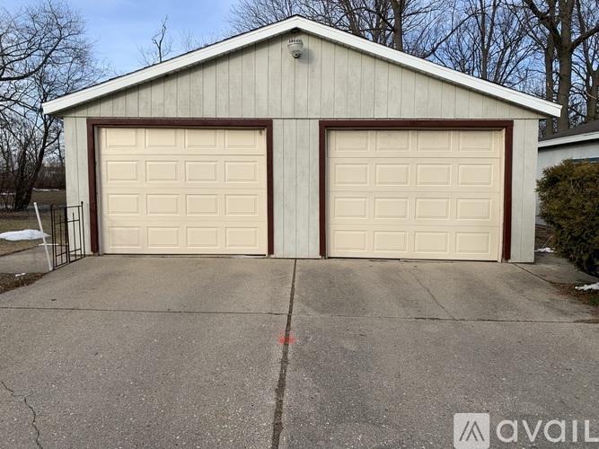 A two-car garage with a white and brown exterior.