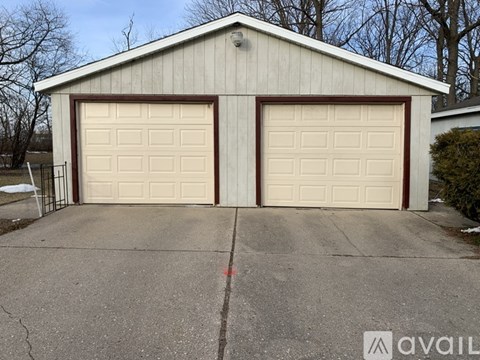 A two-car garage with a white and brown exterior.