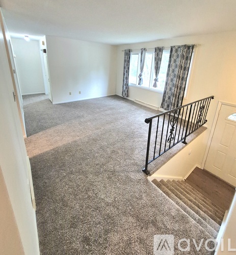 A living room with a staircase leading to the upper floor.