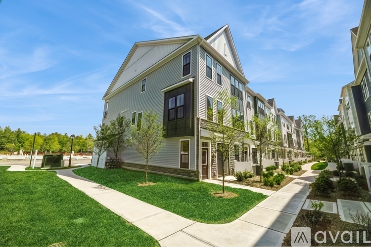 A row of houses with a grassy area in front.