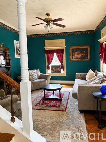 A living room with a couch, chair, and a table.