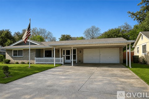 A house with a flag on the front lawn.