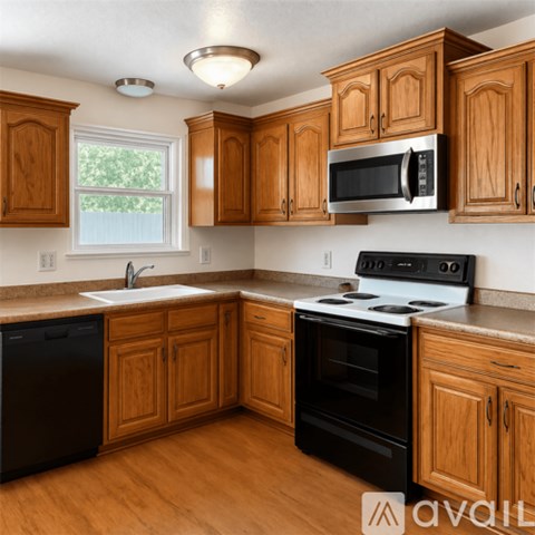 A kitchen with wooden cabinets and black appliances.