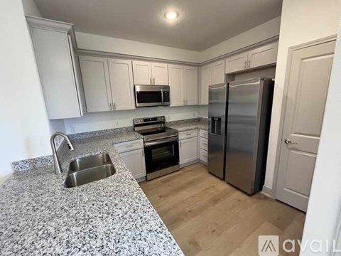 A kitchen with granite countertops and stainless steel appliances.