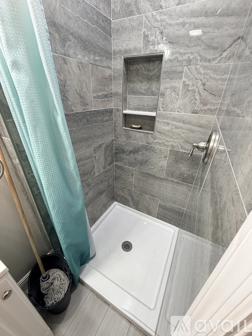 A bathroom with a shower curtain and a white sink.