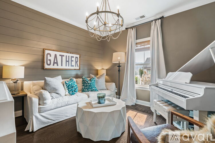 A living room with a white piano and a sign that says "Gather".