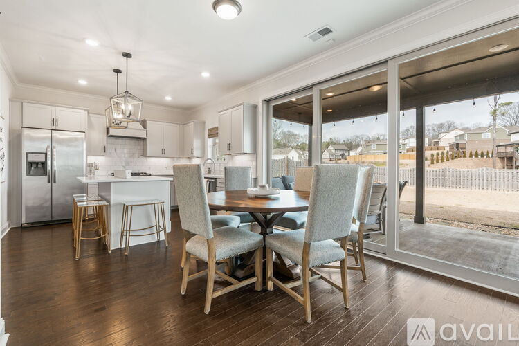 A modern kitchen with a dining table set for four.