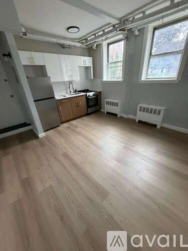 A kitchen with wooden floors and white appliances.