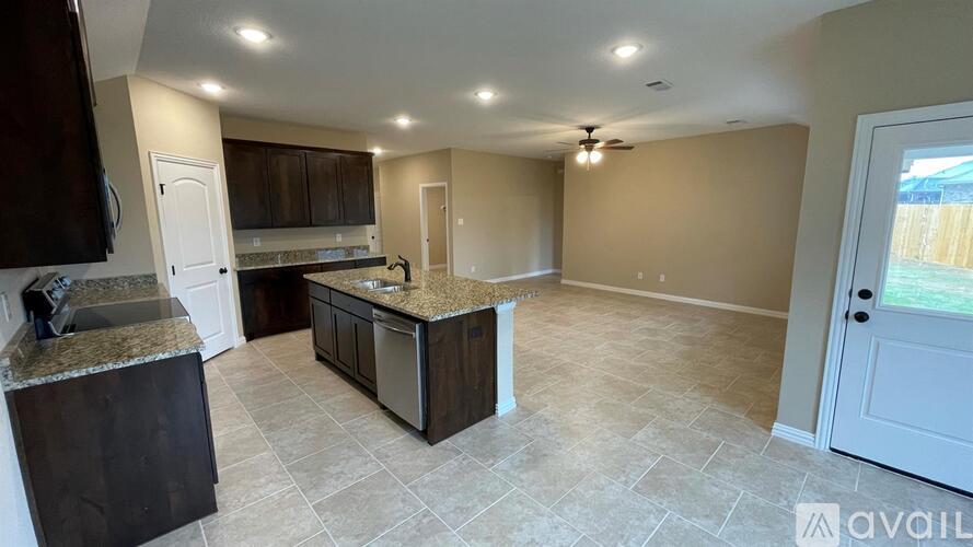 A kitchen with a countertop and cabinets is available for rent.
