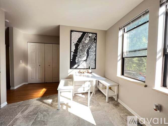 A dining room with a white table and chairs.