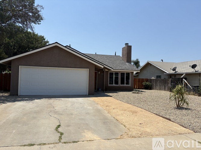 A house with a garage and a driveway in front.