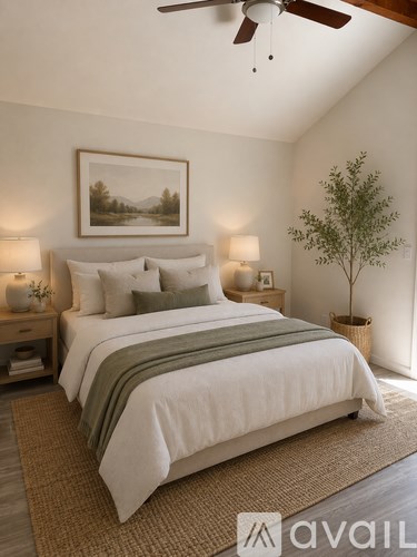 A bedroom with a large bed and a ceiling fan.
