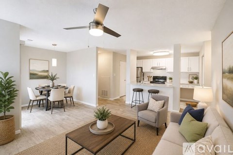 A living room with a dining table and chairs, a couch, and a ceiling fan.