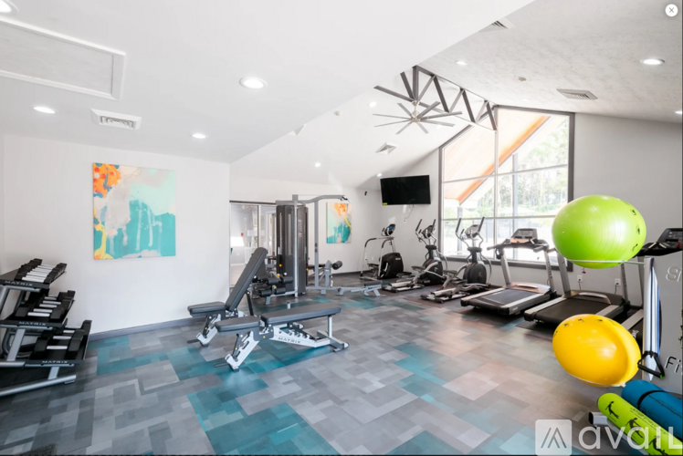 A gym with a variety of equipment including weights, a treadmill, and a stationary bike.