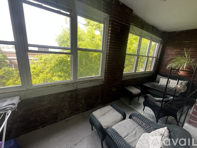 A sunny room with a couch and a table.