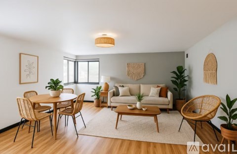 A living room with a wooden floor and furniture.