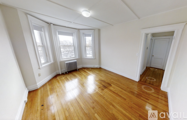 A room with wooden floors and white walls.