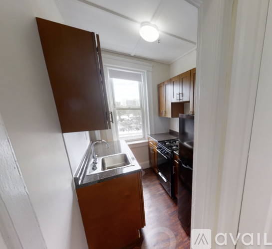 A kitchen with a sink and a refrigerator.