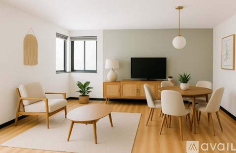 A living room with a wooden floor and furniture.