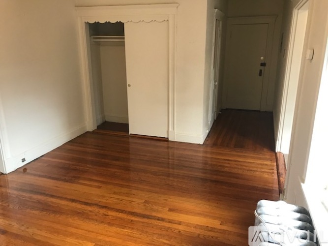 A room with wooden floors and white walls.