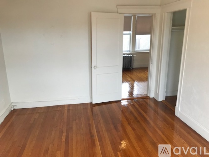 A room with wooden floors and white walls.