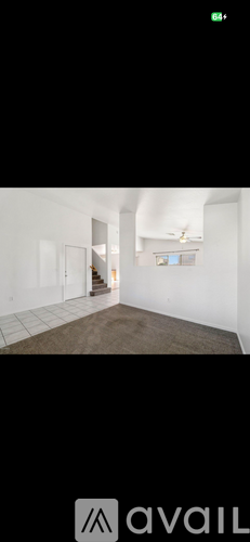 A room with white walls and a brown floor.