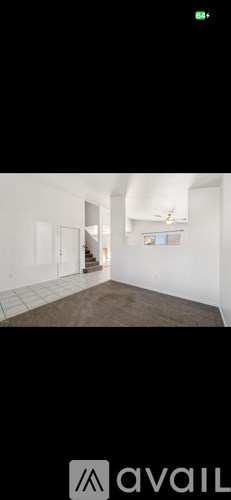 A room with white walls and a brown floor.