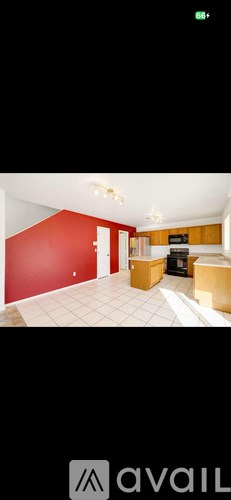 A room with a red wall and a white floor.