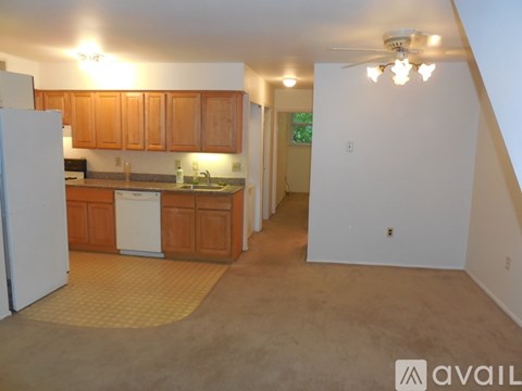 A kitchen with wooden cabinets and a white refrigerator.