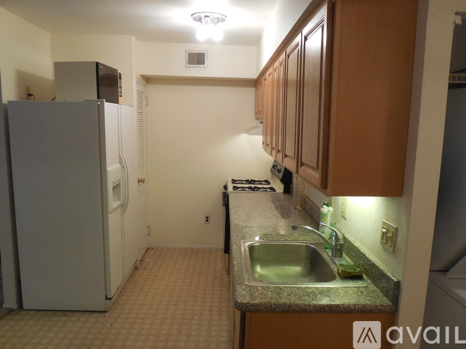 A kitchen with a sink and a refrigerator.